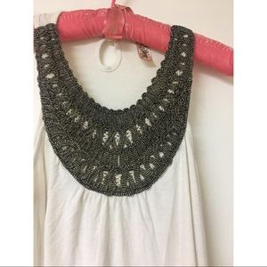 Sleeveless tunic shirt with embellished neck